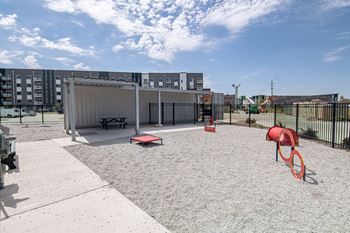 A playground with a slide, swings, and a picnic table.at Linc, Des Moines, IA 50309  